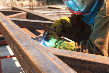 Worker welding in a factory. Welding on an industrial plant.