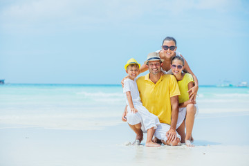 Family of four having fun at the beach