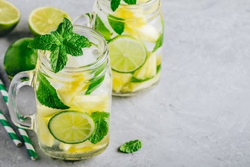 Infused detox water with pineapple, lime and mint. Ice cold summer cocktail or lemonade