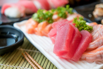 Mixed sliced fish sashimi in white plate. Sashimi Salmon and Tuna set with Tuna, flying fish roe...