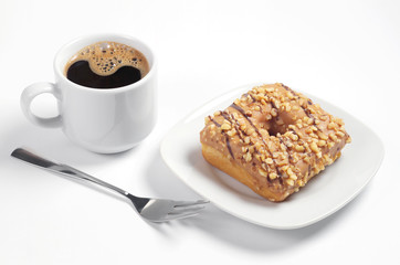 Cup of coffee and donut with glaze