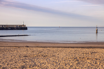 Lighthouse and beach in Peel at sunset