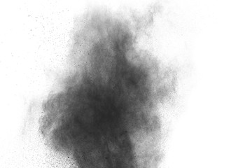 Black powder explosion. Closeup of black dust particles splash isolated on  background.