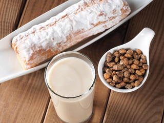 Horchata is a drink, made with the juice of tigernuts and sugar.  Native from Valencia – Spain, it is a refreshing drink, often accompanied with long thin buns called  fartons.