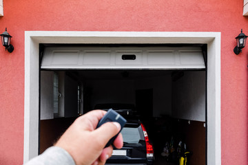 Garage door PVC. Hand use remote controller for closing and opening garage door.