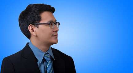 Portrait of young business man on blue background