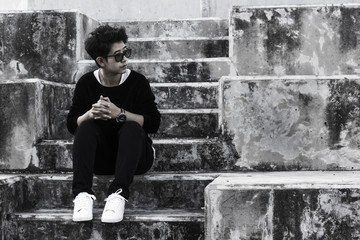 Young Asian desperate in life. Concept of despair in life in the dark tone.