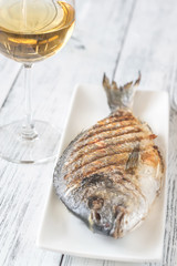 Grilled gilt-head bream on the plate