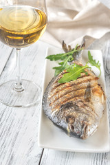 Grilled gilt-head bream on the plate