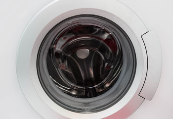 Washing Machine Isolated on White Background. Front View of Stainless Steel Front Load Washer with Electronic Control Panel. Domestic Appliances. Clipping Path