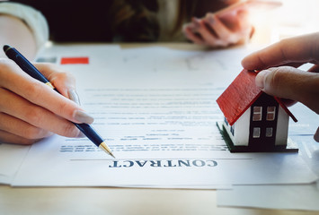 estate agent gives pen and documents agreement with customer to sign contract. Concept agreement