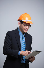 engineer man in suit and helmet working on tablet pc