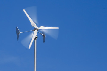 Wind generator spinning against the sky. Concept: renewable energy.
