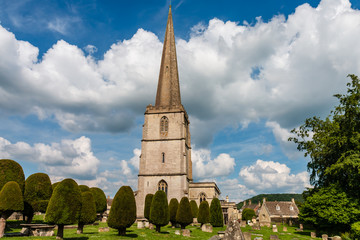 An ancient church and graveyard in the scenic Cotswolds area of England on a summers day (Painswick)