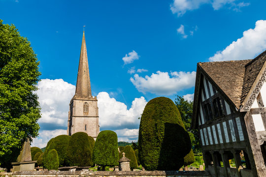 An ancient church and graveyard in the scenic Cotswolds area of England on a summers day (Painswick)
