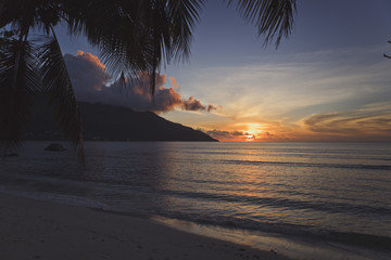 Stunning sunset on the beach of a tropical island.