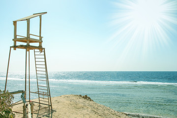 Beautiful tall watch tower on the seashore nature background