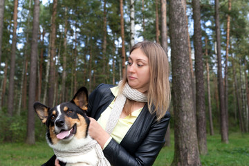 Pretty woman hugging her dog breed welsh corgi cardigan