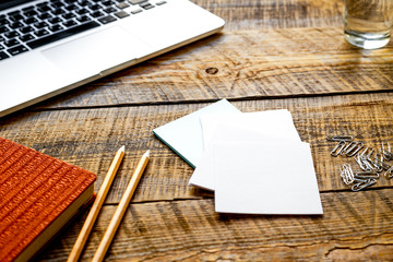 Comfortable working place with wooden table and laptop at sunlig