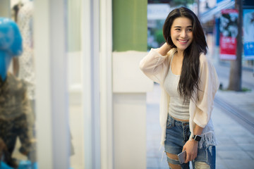 lifestyle fashion portrait of young stylish hipster Asia woman walking on the street, wearing cute trendy outfit
