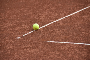 Ball on the line on tennis clay court
