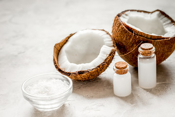 fresh coconut with cosmetic oil in jar on white background
