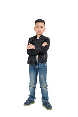 Naklejka premium Full length portrait of the serious little difficult child of the brunette with arms crossed wearing black leather jacket and jeans on a white background in studio.