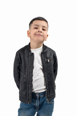 Waist up portrait of the smiling of the little boy  of the brunette wearing  black  leather jacket and jeans  on a white background in studio.