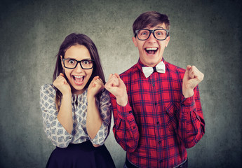 Excited young couple looking thrilled