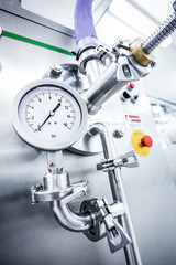 Steel pipelines and valves on trucks transport milk at factory