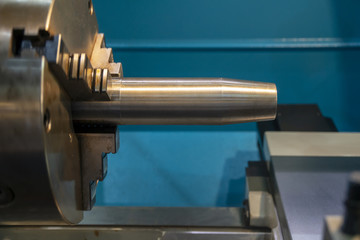 The  lathe machine cutting the steel rod.The high technology manufacturing process.