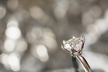 Fototapeta na wymiar luxury engagement Diamond ring in jewelry gift box with bokeh light background