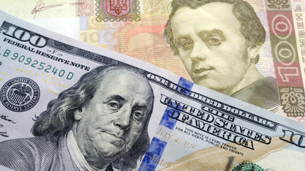 Obraz na płótnie Canvas Ukrainian cash hryvnia and dollars USA. Currency exchange rate concept. Dolar is located near the hryvnia at an angle to each other