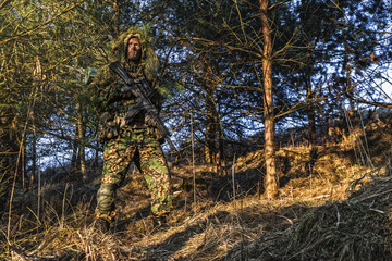 Camouflaged soldier during patrol