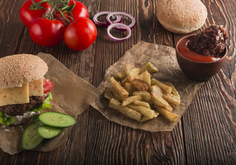Delicious burgers with beef, tomato, cheese and lettuce