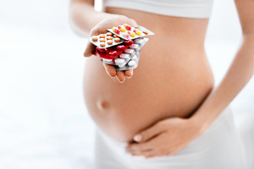 Pregnancy Vitamins And Medications. Pregnant Woman With Pills - obrazy, fototapety, plakaty