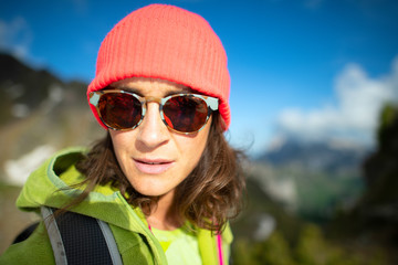 Closeup of caucasian girl with wool cap in the mountains