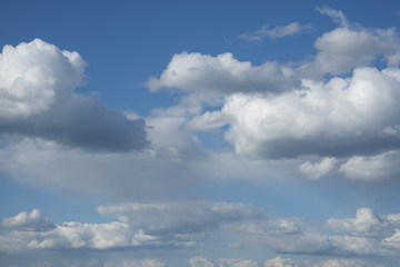 fluffy white clouds against the blue sky