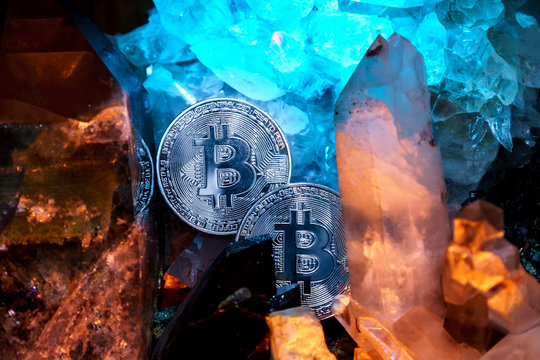 Silver bitcoin in a cave of gem stones