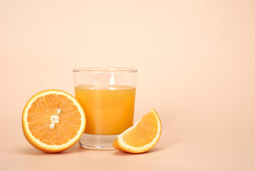 Fresh juice and orange on a beige background with right side place for a text.