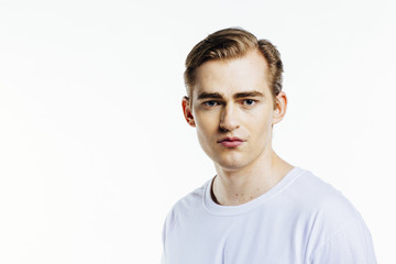 Portrait of a young expressive man on white studio background