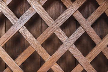 Wooden lattice on the background of wooden wall