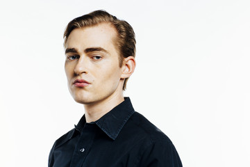 Portrait of a young expressive man on white studio background