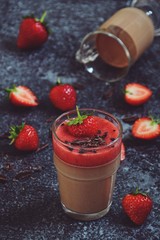 Chocolate panna cotta with strawberry isolated on black
