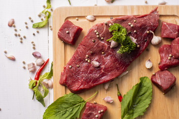 Raw beef on white wood background