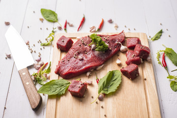 Raw beef on white wood background