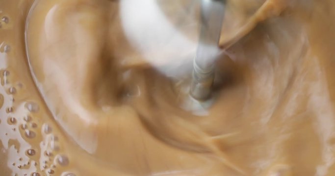 Close video of using beaters to make homemade mocha instant pudding.