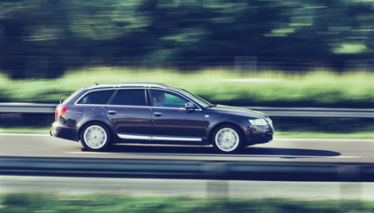Obraz na płótnie Canvas Car driving fast on highway motion blur
