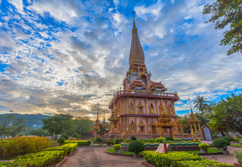 Fototapeta premium cloudy sunset above beautiful pagoda in Chalong temple Phuket Thailand
