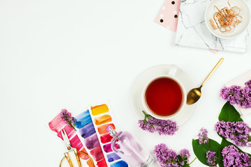 Lifestyle and business mockup flatlay with cup of tea, lilac, notebook, perfume and other accessories on white with copyspace